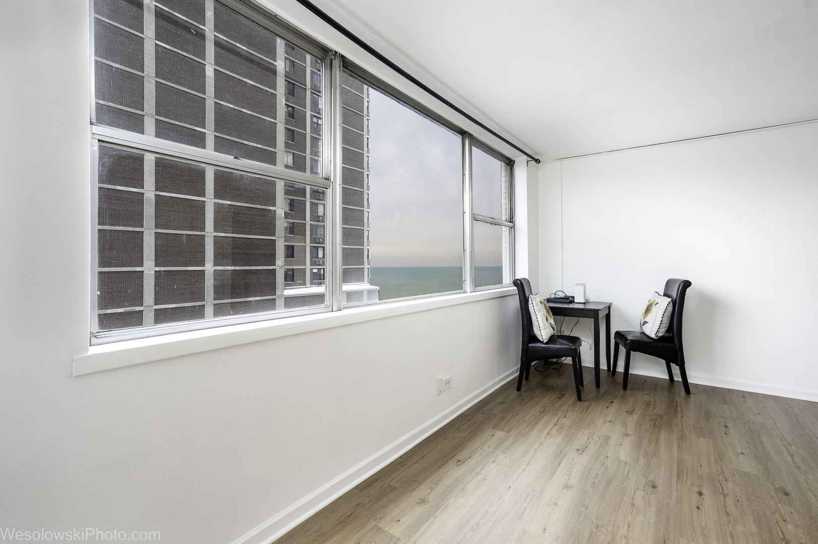 6301 North Sheridan Road, Unit 6C Chicago, IL 60660 - Photo 5 of 20 a view of a workspace with furniture and a window