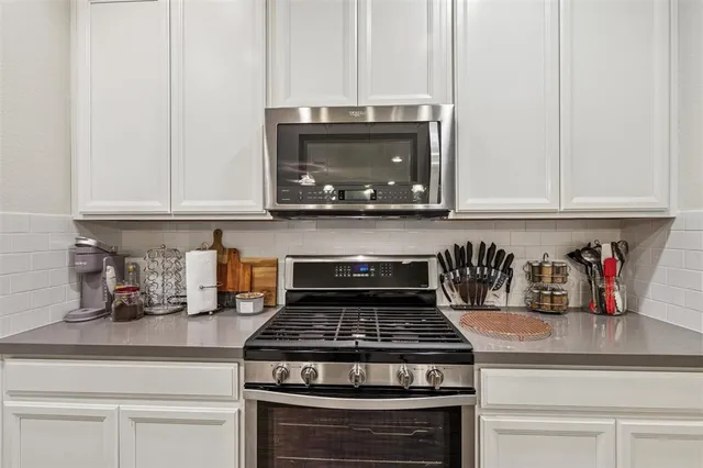 a stove top oven sitting inside of a kitchen