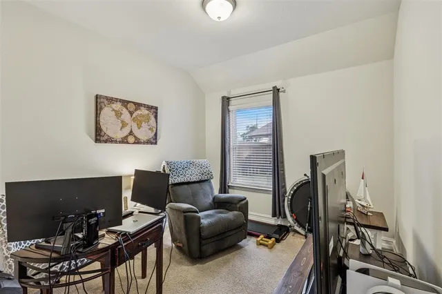 a work room with furniture and a flat screen tv
