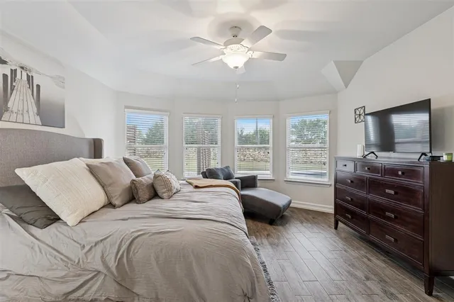 a bedroom with a bed and a flat screen television