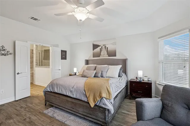 a bedroom with a bed couch and window