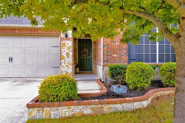 a view of a house with a small yard and plants
