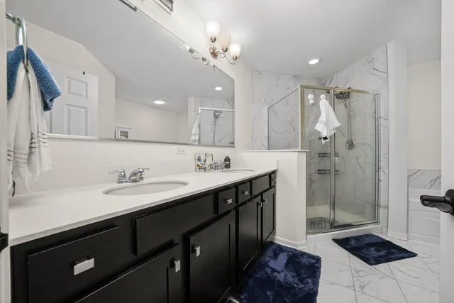 a spacious bathroom with a sink a toilet a mirror and shower