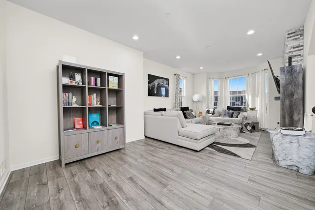 a living room with furniture and a book shelf