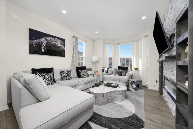 a living room with fireplace furniture and a flat screen tv