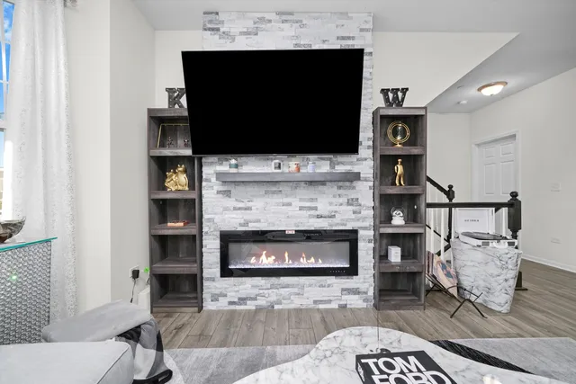 a living room with a flat screen tv and a fireplace