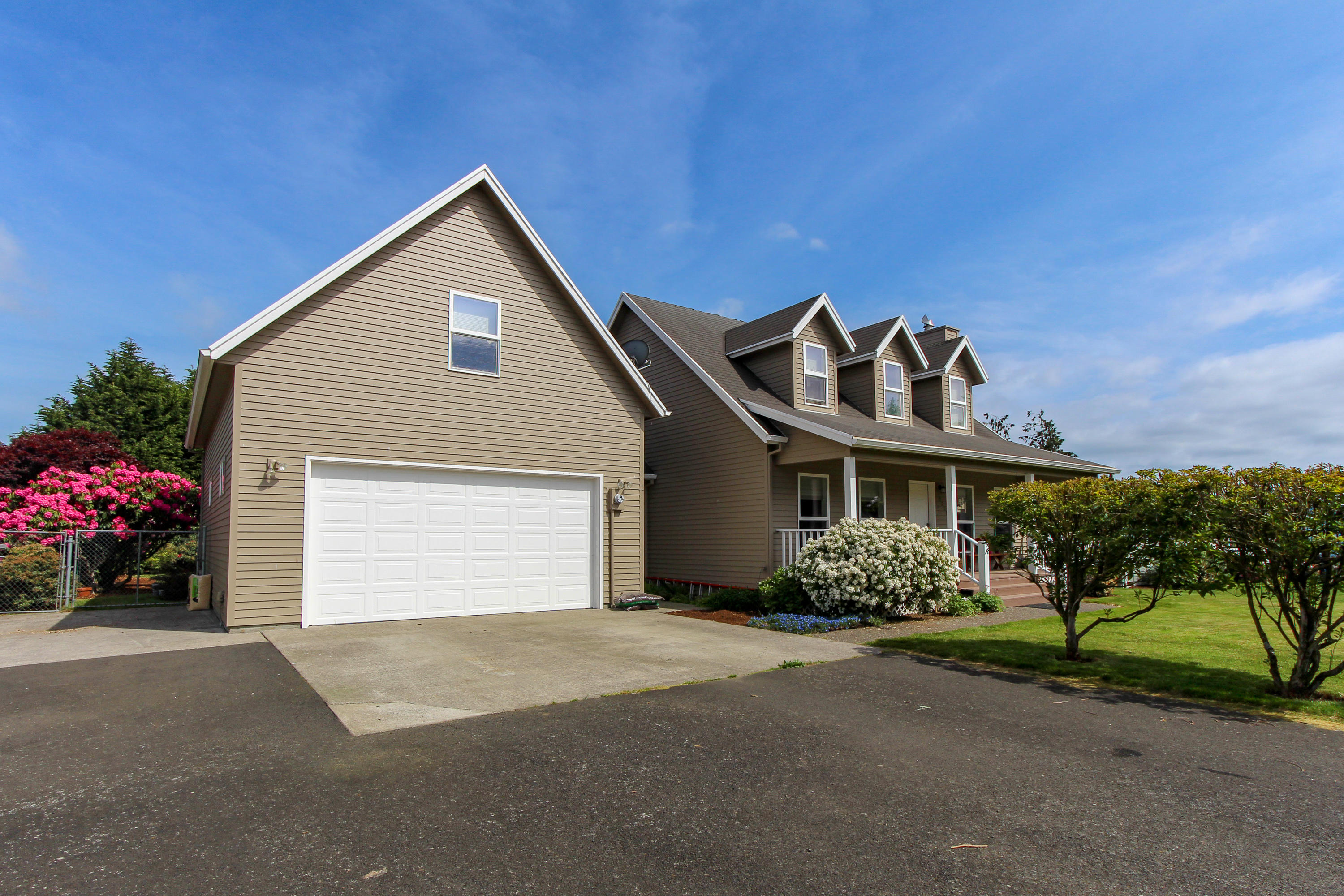 3225 Fitzpatrick Road Tillamook, OR 97141 - Photo 23 of 50 a front view of a house with a garden