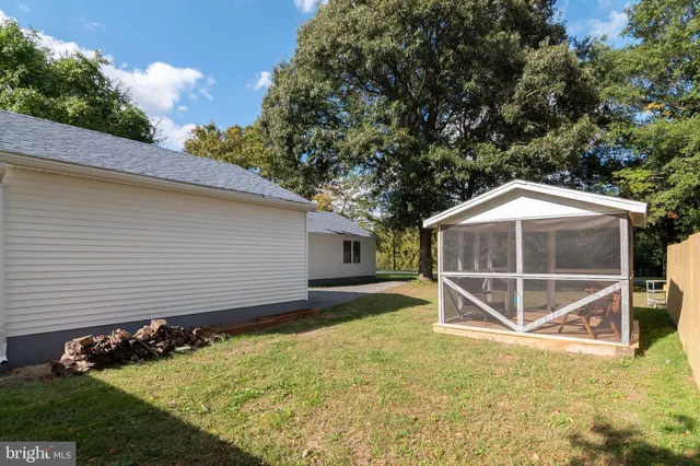 a backyard of a house with wooden fence and roof