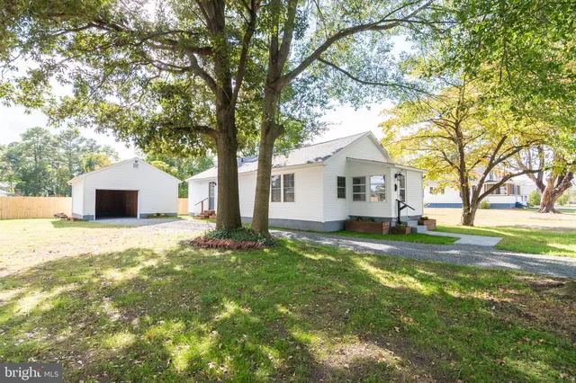 a view of a house with a yard and tree