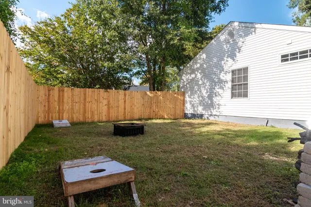 a backyard of a house with table and chairs