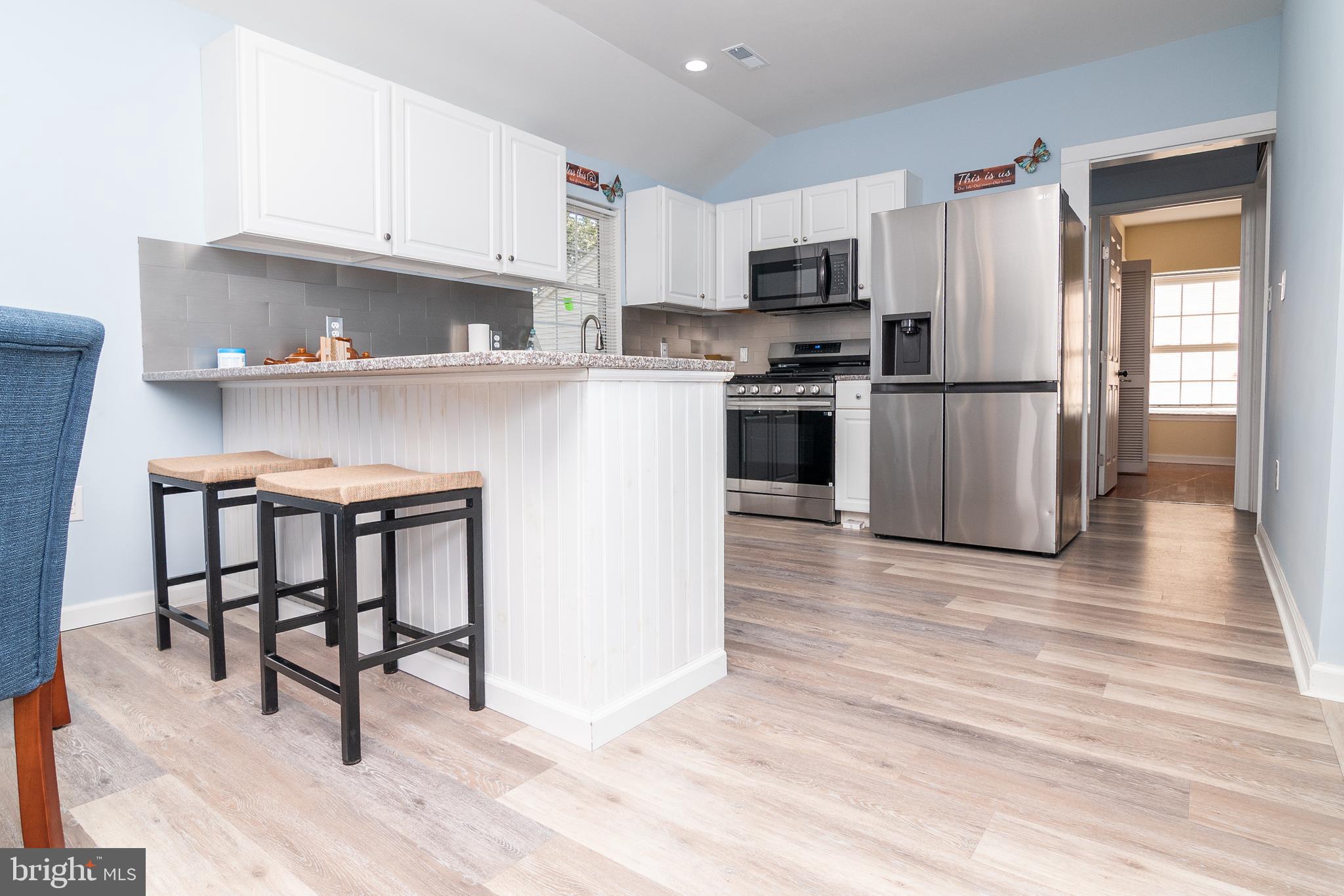 1154 West 6th Street Laurel, DE 19956 - Photo 6 of 27 a kitchen with granite countertop a refrigerator stove top oven and sink