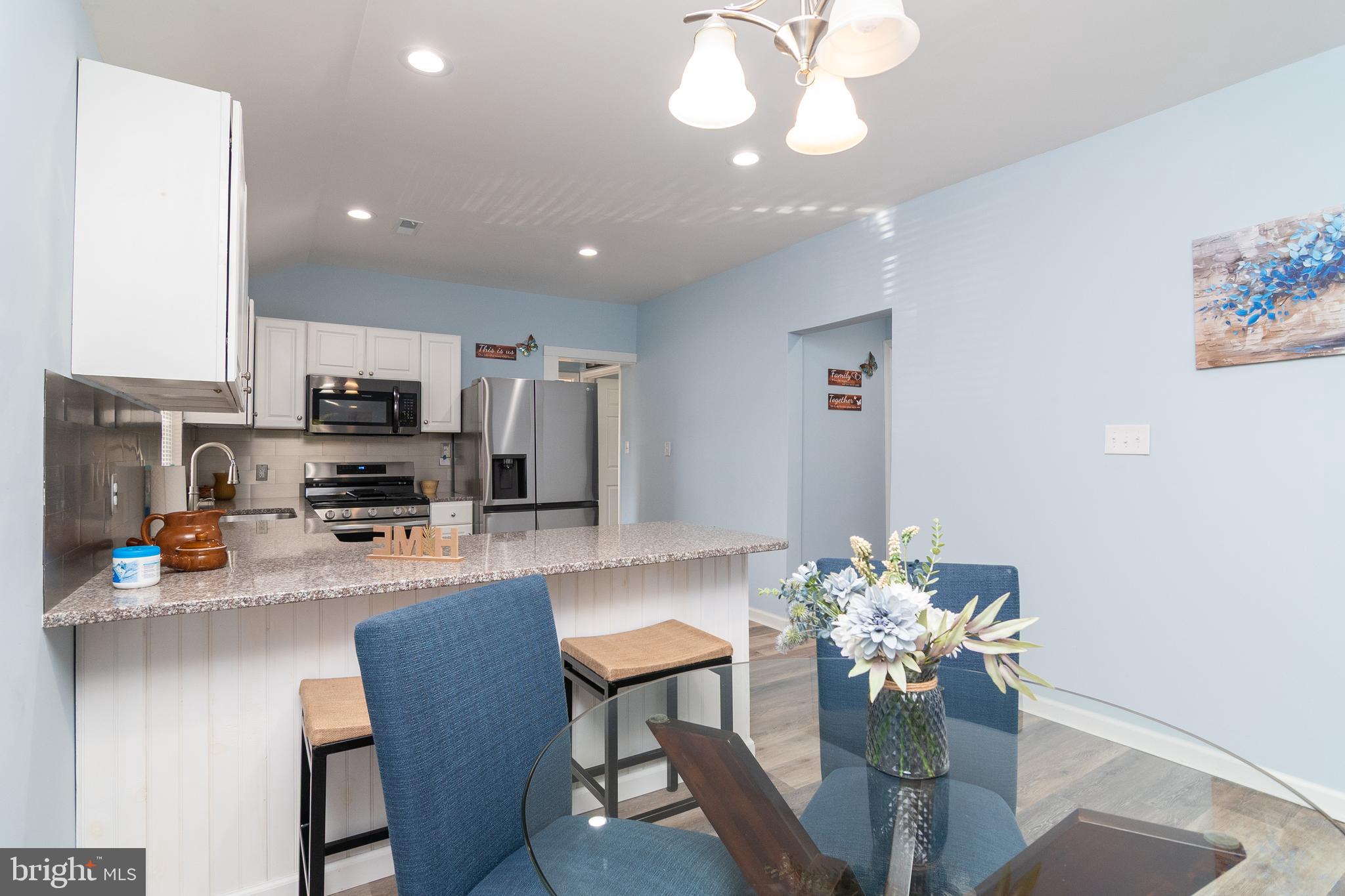 1154 West 6th Street Laurel, DE 19956 - Photo 10 of 27 a kitchen with stainless steel appliances granite countertop a refrigerator sink cabinets and wooden floor