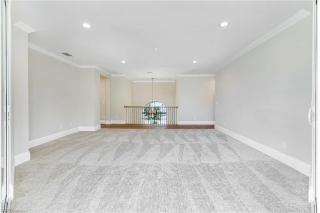 an empty room with a ceiling fan and window
