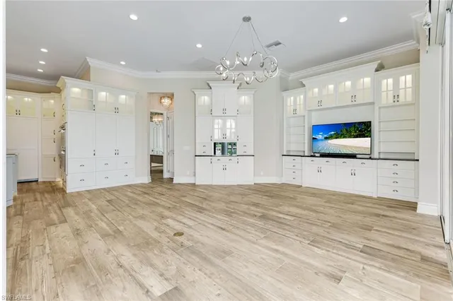 a view of a kitchen with granite countertop cabinets and chandelier