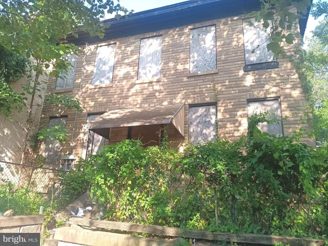 a backyard of a building with trees in the background