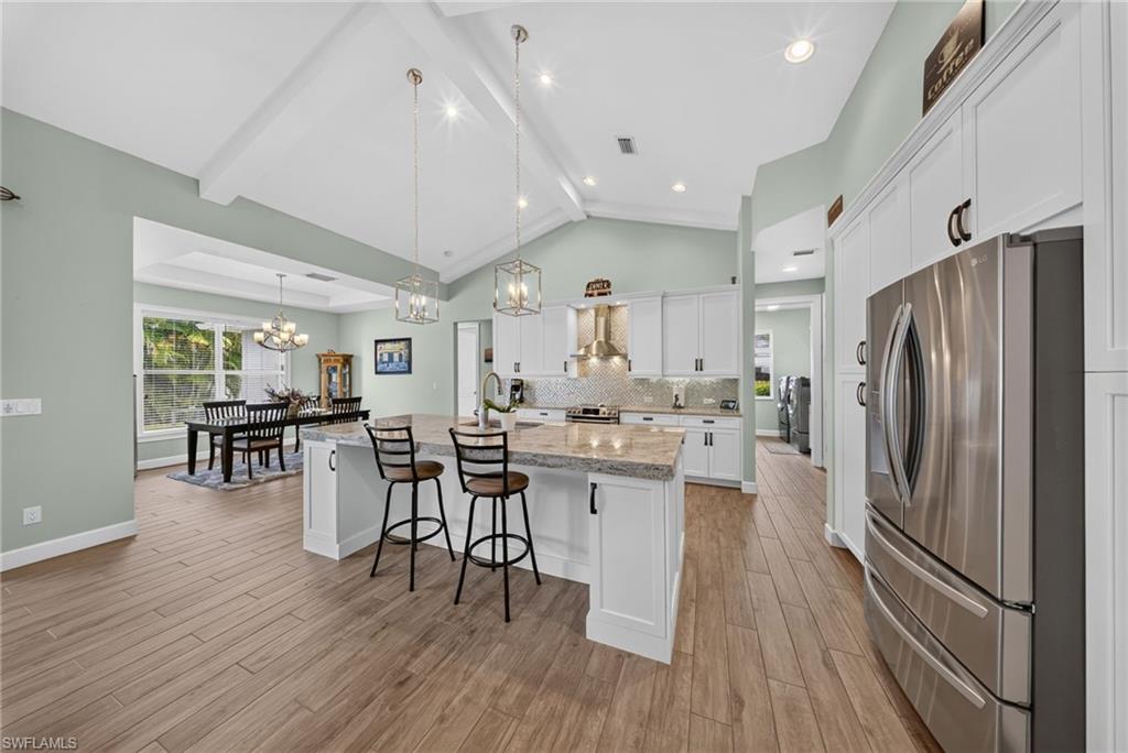 37 Johnnycake Drive Naples, FL 34110 - Photo 25 of 33 Welcoming entryway featuring light blue double doors, grey paver walkway, and white architectural columns