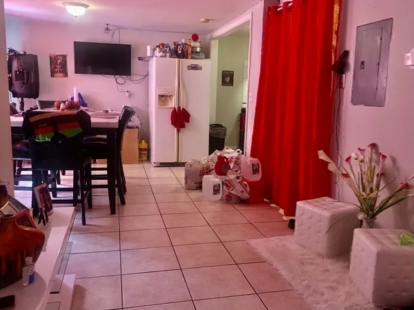a view of a livingroom with furniture and a flat screen tv