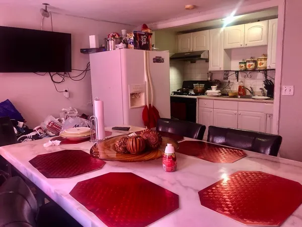 a kitchen with stainless steel appliances a sink a stove a refrigerator and cabinets
