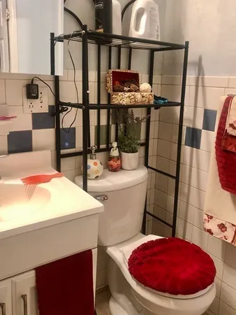 a bathroom with a toilet and a mirror