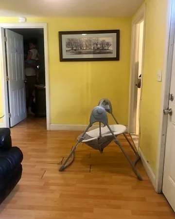a room with wooden floor and furniture