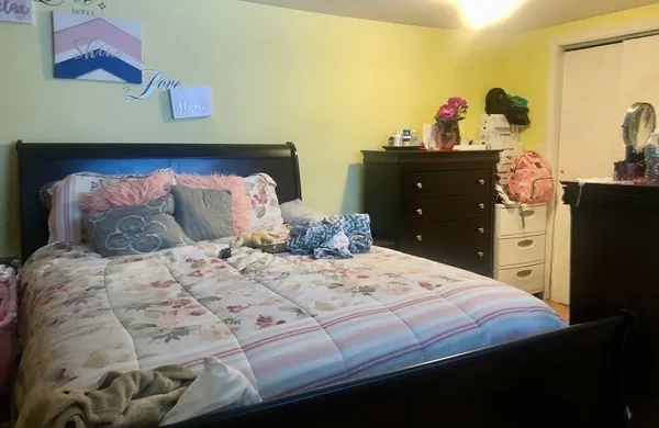 a bedroom with a bed and a dresser