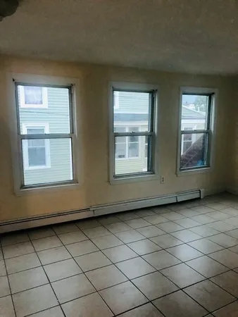 a view of an empty room and a window