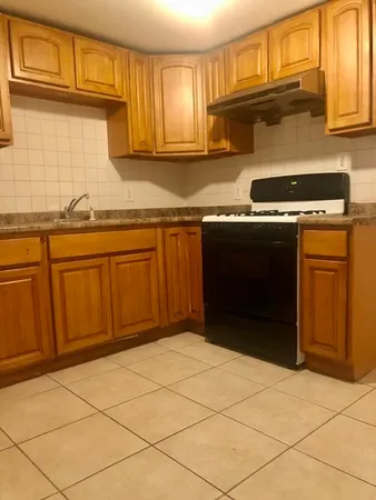 a kitchen with granite countertop a sink and cabinets