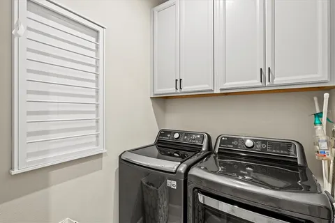 a bedroom with furniture and a flat screen tv