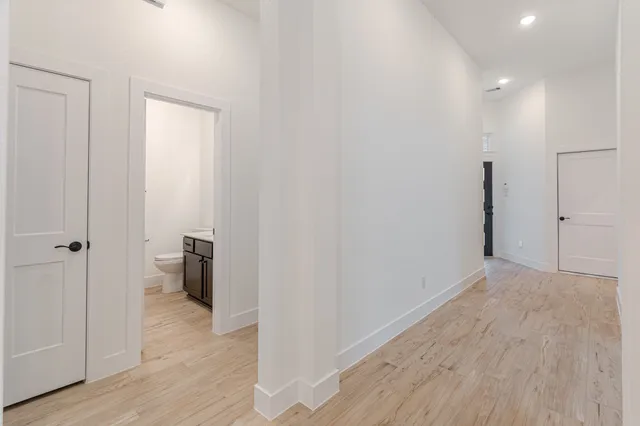 a view of hallway with wooden floor