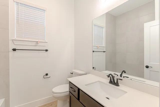 a bathroom with a sink toilet and vanity