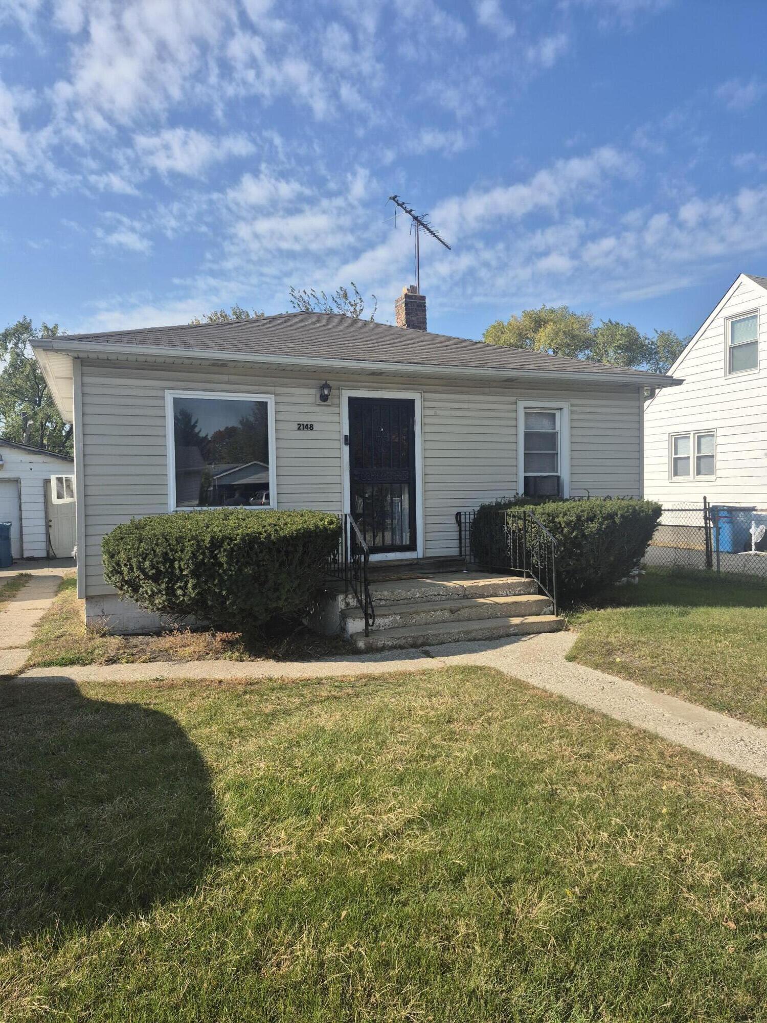 2148 Cleveland Street Gary, IN 46404 - Photo 1 of 2 a view of a house with backyard and a tree