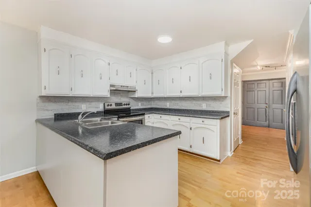 a view of an empty room with window and fire place