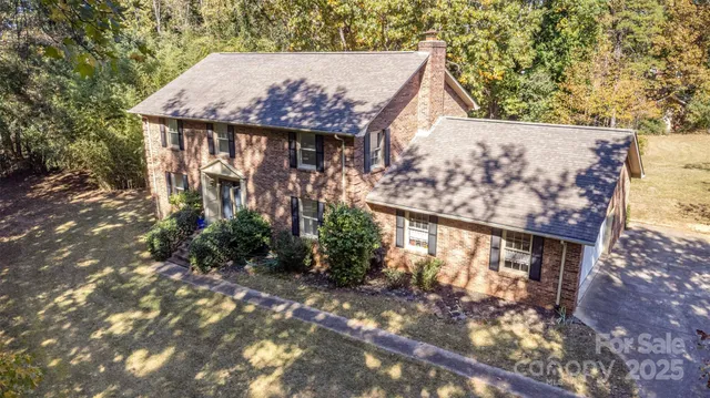 a view of a wooden house with a tree