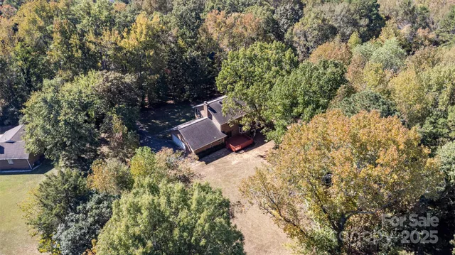 a backyard of a house with outdoor seating and trees