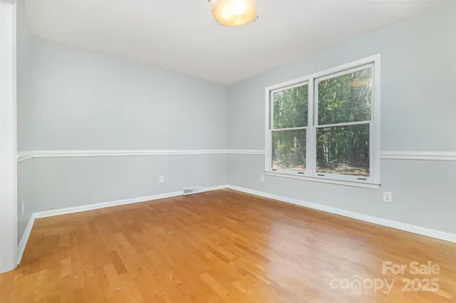 a kitchen with stainless steel appliances granite countertop a stove a sink and a white cabinets