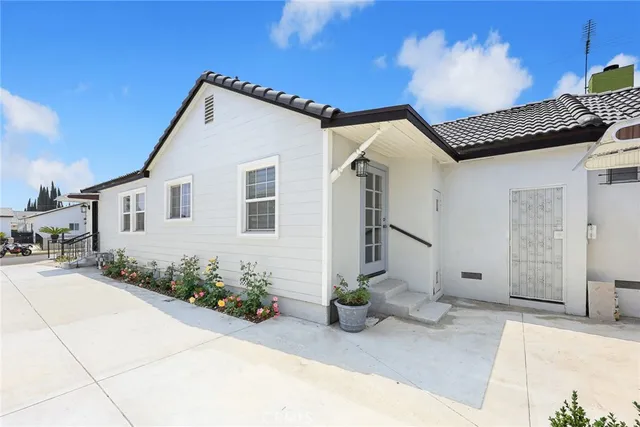 a view of a house with potted plants