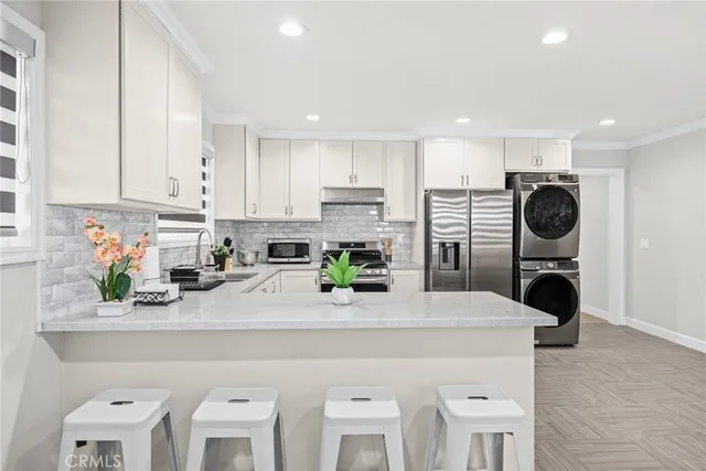 a view of kitchen with sink microwave and stove