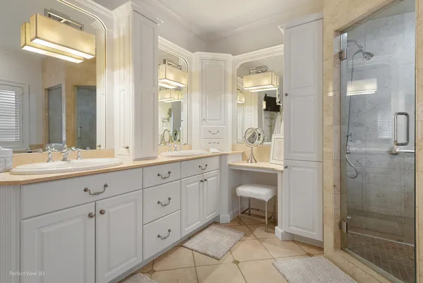 a bathroom with a double vanity sink a toilet and a shower
