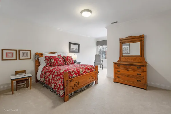 a spacious bedroom with a bed and a cabinets