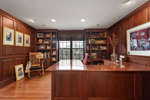 a living room with furniture a bookshelf and wooden floor
