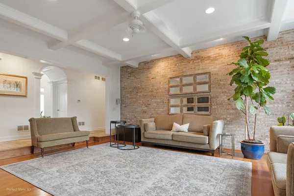 a living room with furniture and a potted plant