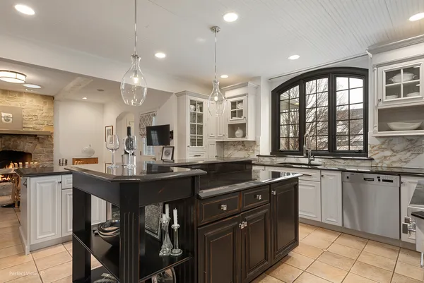 a kitchen with granite countertop a sink and cabinets