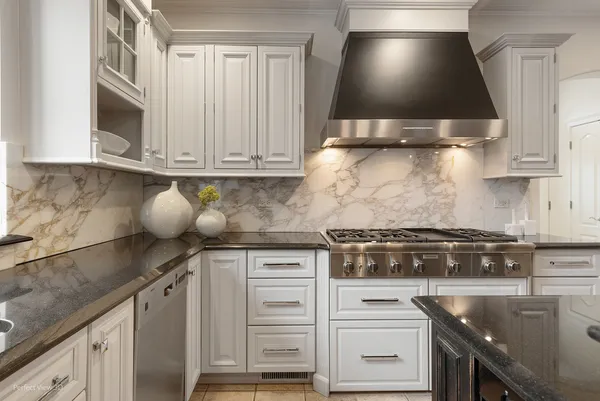 a kitchen with granite countertop a stove and a sink