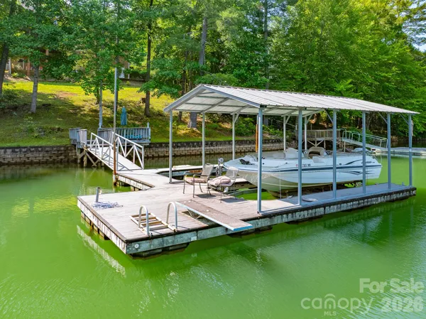 a view of a house with a backyard patio and swimming pool