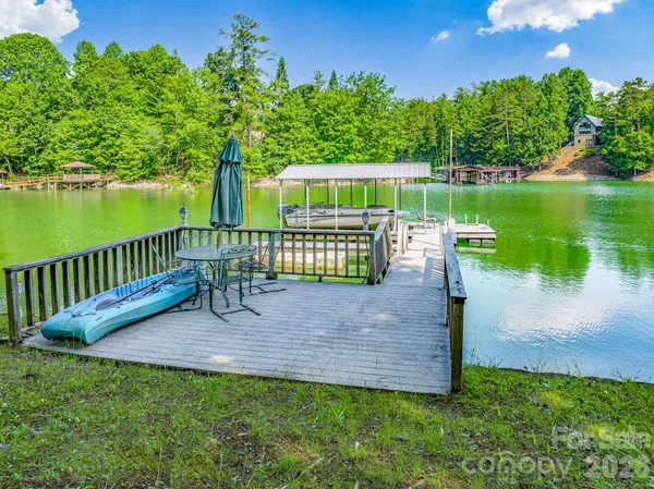 a view of a bench in the garden near a lake