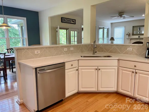a kitchen with a sink cabinets and wooden floor