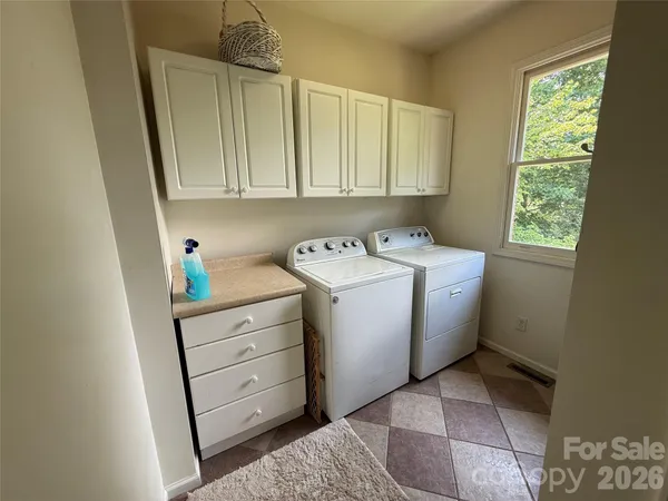 a utility room with closet dryer and washer