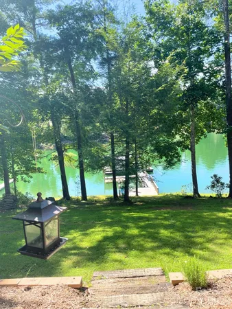 a view of yard with swimming pool and bench