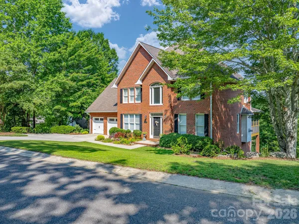 a front view of house with yard and green space