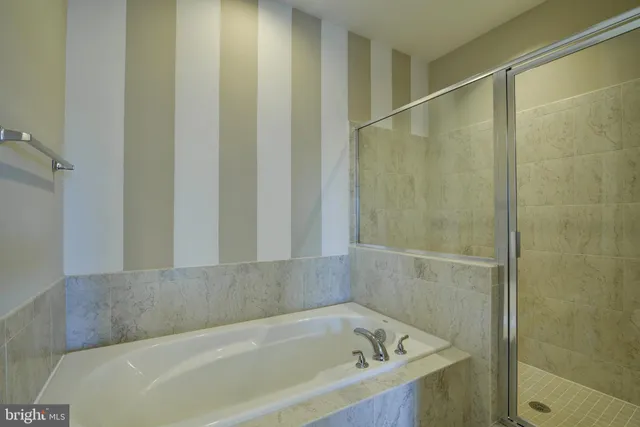 a bathroom with a bathtub and a shower